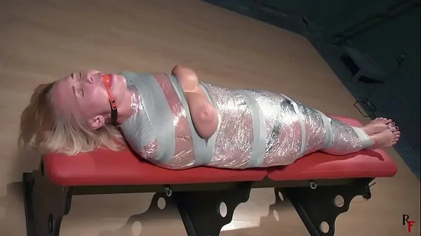 bondage-device,topless,ballgagged,wrapped-girl,mummification